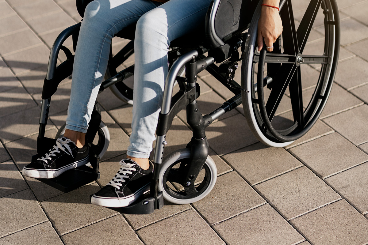 A close up image of a woman using a wheelchair