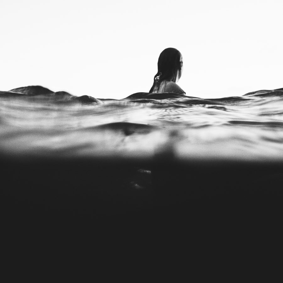 A close up image of a woman swimming in water