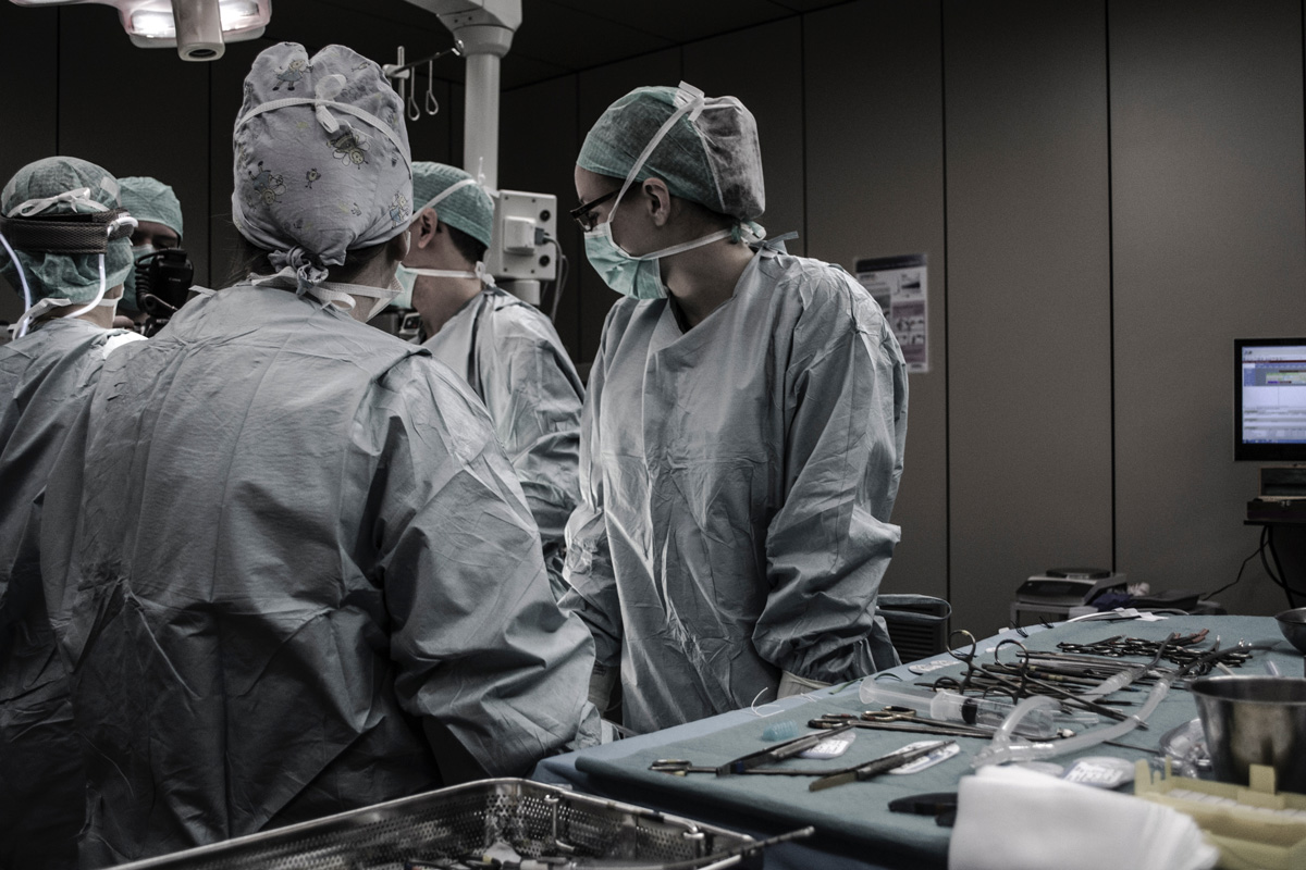 A group of men and women working together in an operating theatre